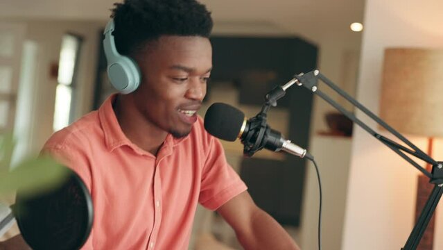 Podcast influencer man with microphone, headphones and home office studio talking for online live streaming audio service. Gen z radio host, music artist or rapper for content creation in living room