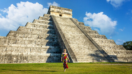 A girl in front of the Pyramid of Kukulkan in the Mexican city of Chichen Itza. Yucatan, Mexico