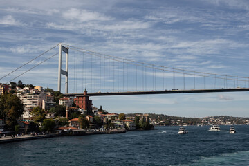 View of boats on Bosphorus, Rumeli Hisari neighborhood on European side and FSM bridge in Istanbul. It is a sunny summer day. Beautiful travel scene.