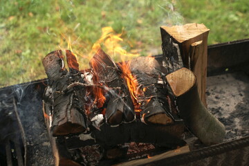  firewood is burning in the grill