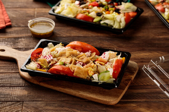 Fatoosh with tomato and salad served in a dish isolated on wooden table background side view of fastfood