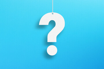White question mark suspended by rope on blue background