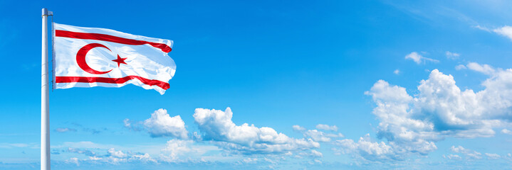 Northern Cyprus flag on a blue sky *** Horizontal banner 12000 x 4000 px