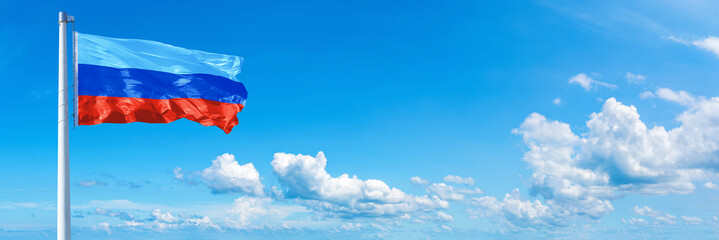Luhansk People's Republic flag on a blue sky *** Horizontal banner 12000 x 4000 px