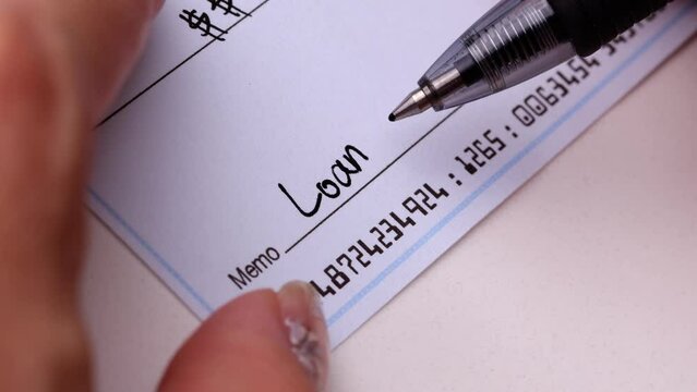 Close-up shot of a check being writen.