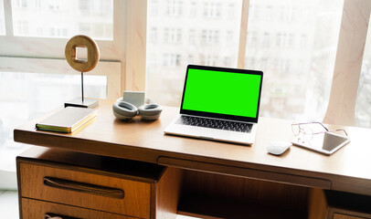 Green laptop screen workplace stylish office.