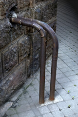 An iron spillway pipe sticking out of the house. Sewer pipe.