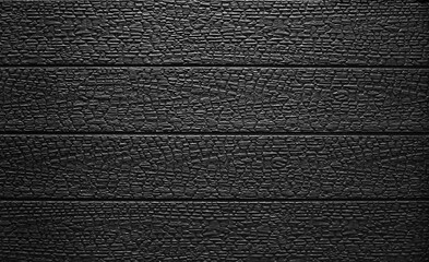 Black burned wooden board texture. Burned scratched hardwood surface.  Burnt wooden Board....