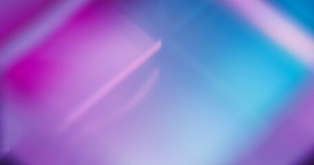 Luminous abstract background. Blur neon light. Bokeh rays. Defocused velvet violet purple pink blue color gradient futuristic copy space wallpaper.