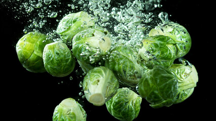 Cabbage pieces splashing underwater.