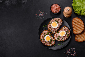 Delicious healthy sandwich with tuna, croutons, boiled egg, herbs and butter