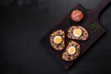 Delicious healthy sandwich with tuna, croutons, boiled egg, herbs and butter