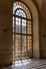 An ancient arch window in a general plan in the Palace of Versailles.