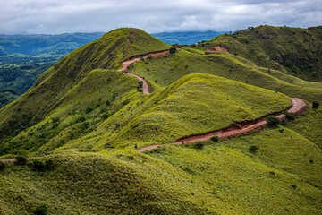 Naklejka premium cerro pelado - costa rican mountains covered with juicy grass - idyllic tropical landscape with blue sky and clouds
