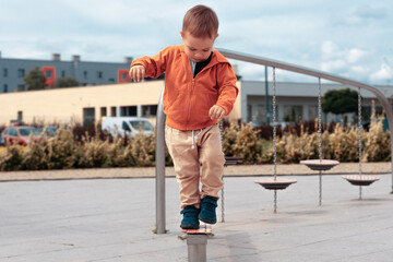 Children playing on playground. Kid balancing concept. Boy keeps balance on the log. Childhood, active lifestyle, happyness symbol - 531770653