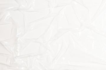Wrinkled plastic wrap on white color background. Crumpled transparent plastic cellophane....