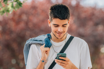 young man looking at mobile phone in the street