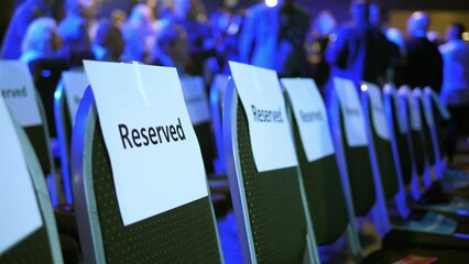 Reserved seating at indoor event. Shallow depth of field.
