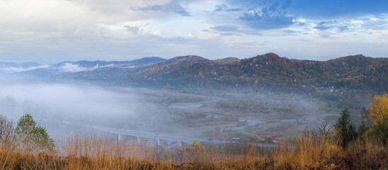 Morning fog on country foothills above Opir and Stryi rivers, and slopes of the Carpathian Mountains in far, Ukraine.