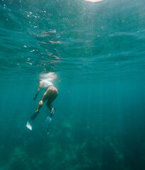 Girl Spearfishing in Turquoise water