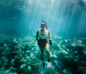 Girl Spearfishing in Turquoise water