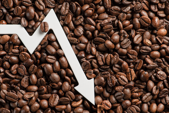 Lower prices for black coffee beans. Poor harvest of coffee beans, world food crisis. Decline in the cost of coffee futures and derivatives.Decrease graph, arrow pointing down
