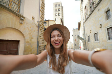 Fototapeta premium Self portrait of beautiful tourist girl in the historic town of Arezzo, Tuscany, Italy