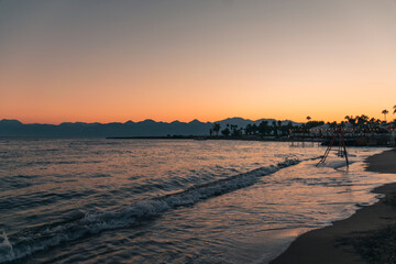 Bright, beautiful sunset on the sea with mountain views.