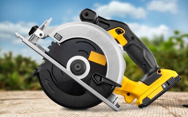 Naklejka premium Circular saw electric tool on the natural background