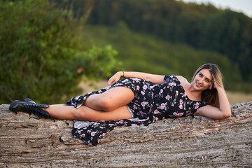 Indian plus size woman sitting on a tree stump