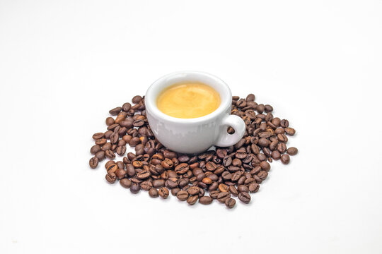 coffee beans with espresso on white background