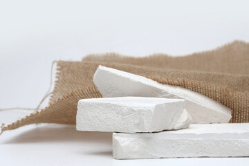 Stack stones platform podium and canvas fabric on gray light copy spase background. Minimal empty...