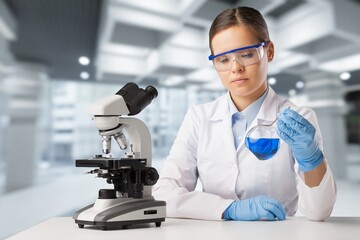 Happy young pharmacist do tests at laboratory