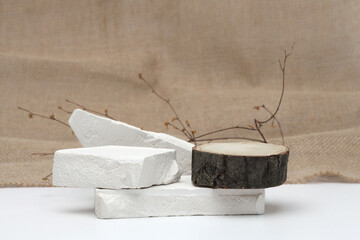 Stack stones and wood platform podium on canvas copy space background. Minimal empty display...