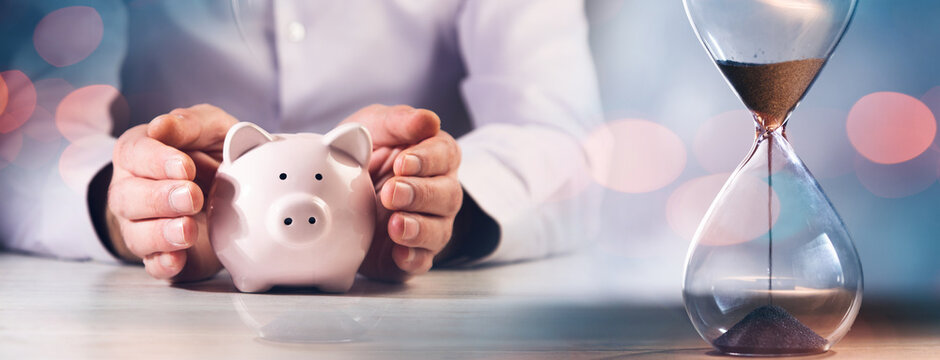 Man Holding Piggy Bank With Time