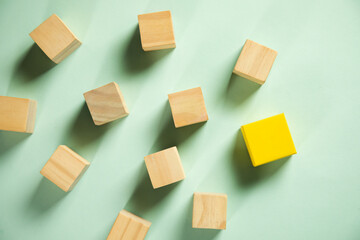Blank wooden cubes and yellow one stacked