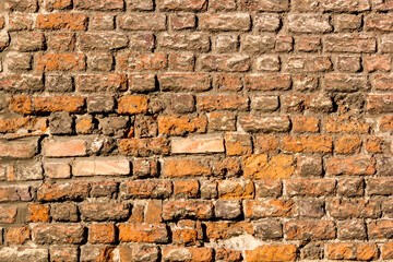 Weathered antique wall, ancient brick masonry closeup, horizontal grunge background