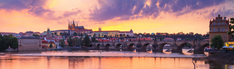 City summer landscape at sunset, panorama, banner - view of the Charles Bridge and castle complex...