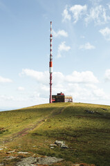 Broadcasting tower on the top of Kralova Hola mountain in Slovakia - Low Tatras. Beautiful and stunning scenic view of green meadow and top of hill. © Matt Benzero