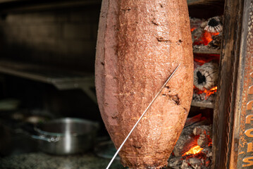Chef cutting traditional Turkish food Shawarma meat Doner Kebab in the outdoor restaurant. ,...