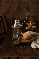 Homemade croissant and coffee kettle on wood table and relax time break concept. Coffee set at table