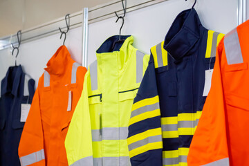 Jackets with reflective stripes - road workers special clothing. Workwear, protection clothing and...