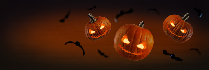 Smiling scary Halloween pumpkins on a dark background