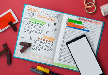 Bullet journal page with handwriting, Bullet Journal-style notebook is opened on habit and book...