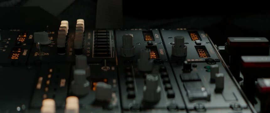 CU Commercial aircraft pilots adjusting radio channel parameters during the flight at high altitude. View from inside the cabin. Real aircraft, daytime shot