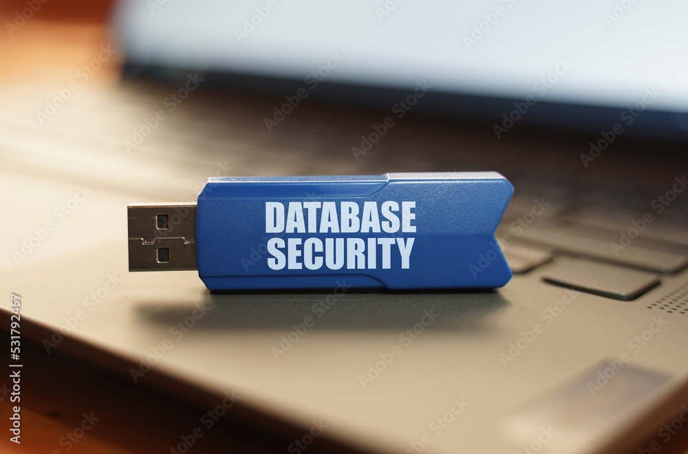 Poster on the laptop keyboard is a flash drive with the inscription - database security