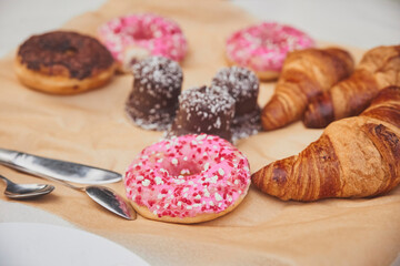 Donuts, croissants and sweets on craft paper
