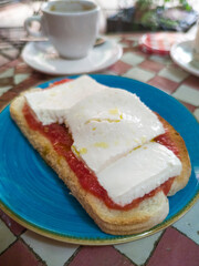 Cottage cheese and tomato toast over glazed tile mosaic table