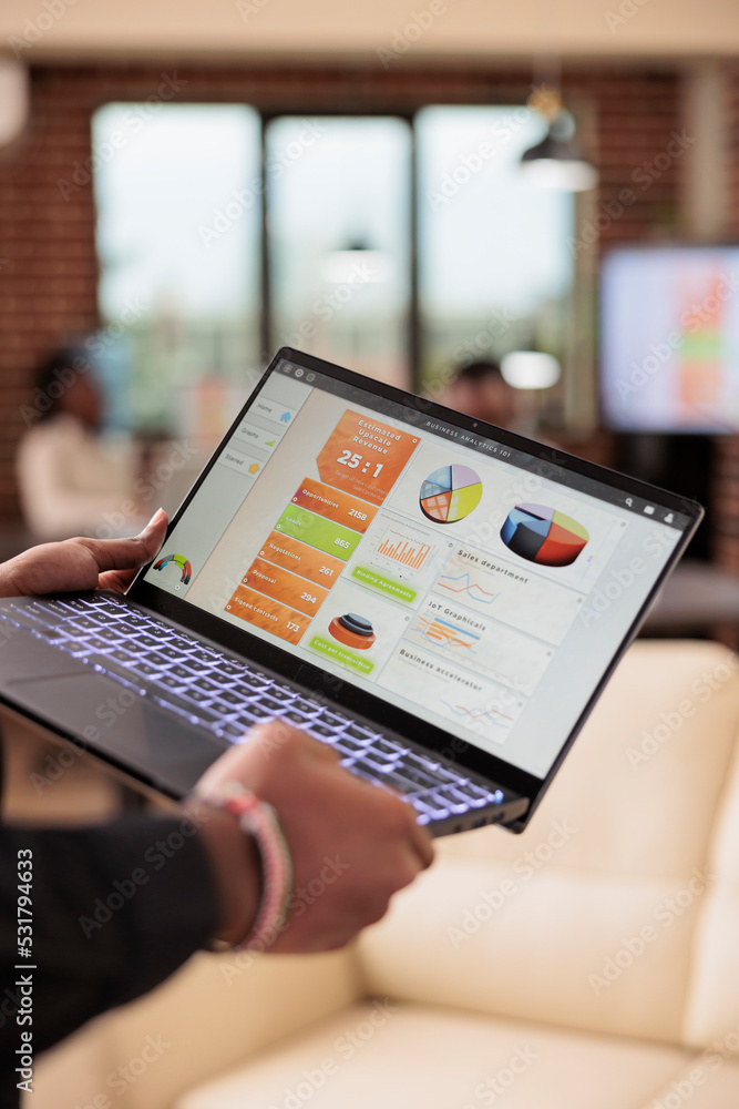 Poster man holding laptop with business charts in company office, management presentation of diagrams and g