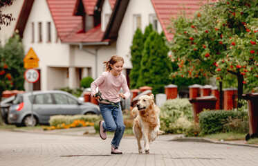 Preteen girl with golden retriever dog